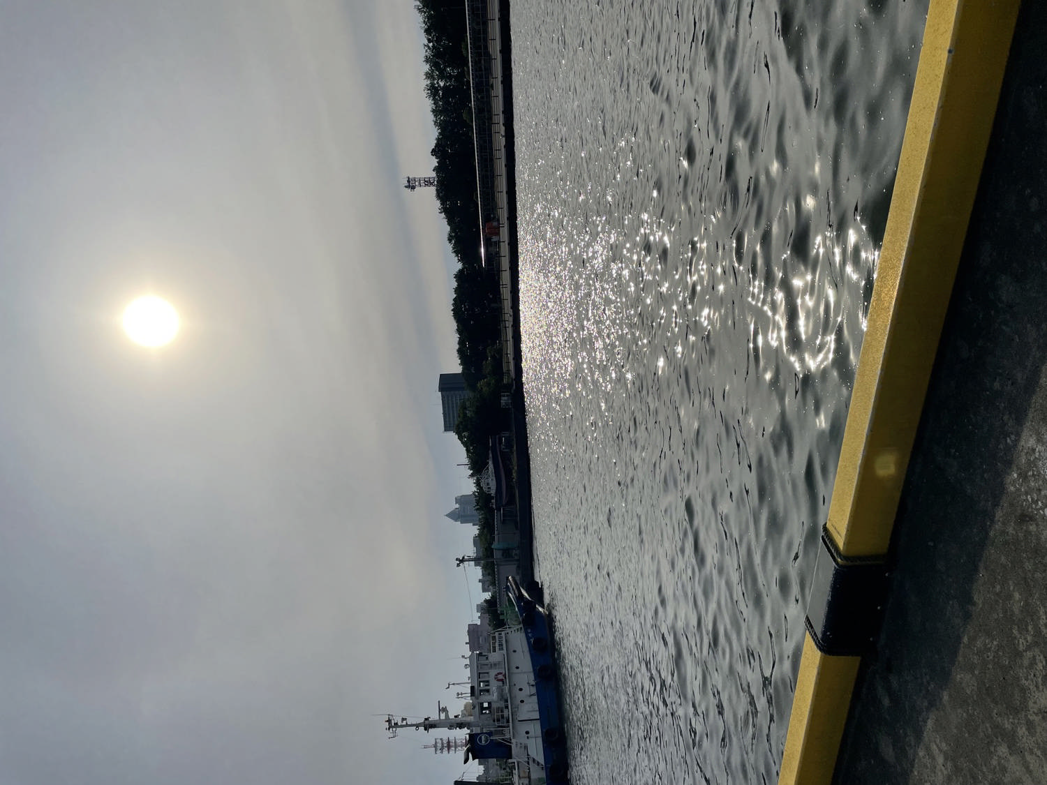 水面に映る太陽と停泊する船
